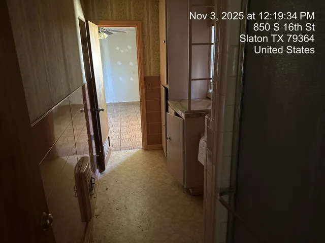 a view of a livingroom with wooden floor and a fireplace