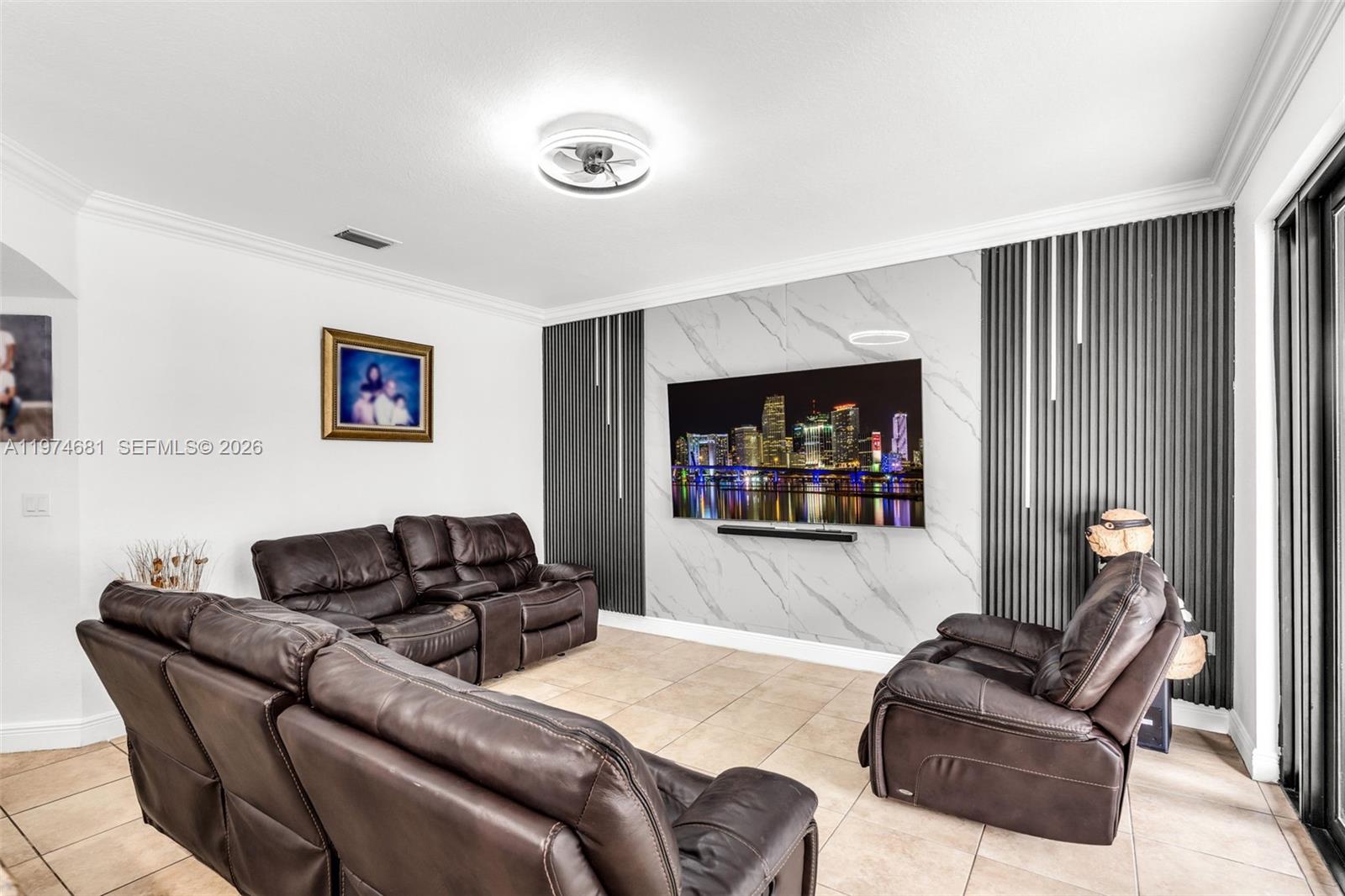 16610 Southwest 57th Lane Miami, FL 33193 - Photo 15 of 57 a living room with furniture and a flat screen tv