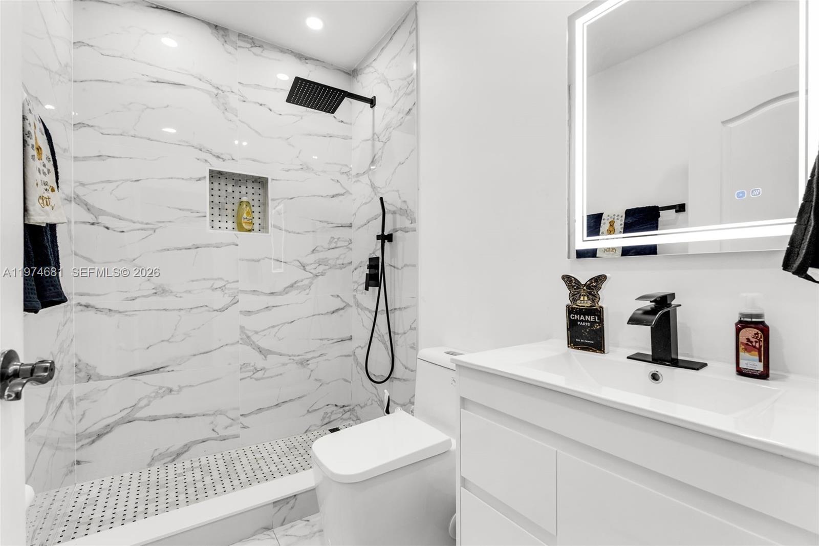 16610 Southwest 57th Lane Miami, FL 33193 - Photo 18 of 57 a bathroom with a sink toilet and shower