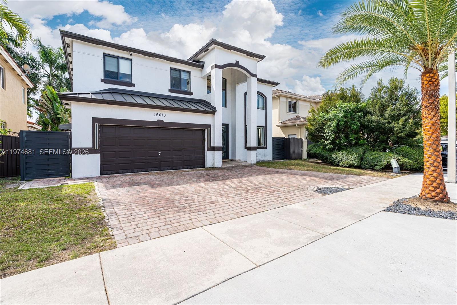 16610 Southwest 57th Lane Miami, FL 33193 - Photo 2 of 57 a front view of a house with a yard and garage