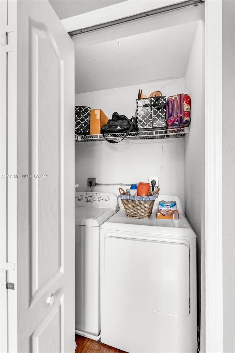 16610 Southwest 57th Lane Miami, FL 33193 - Photo 23 of 57 a utility room with dryer and cabinets