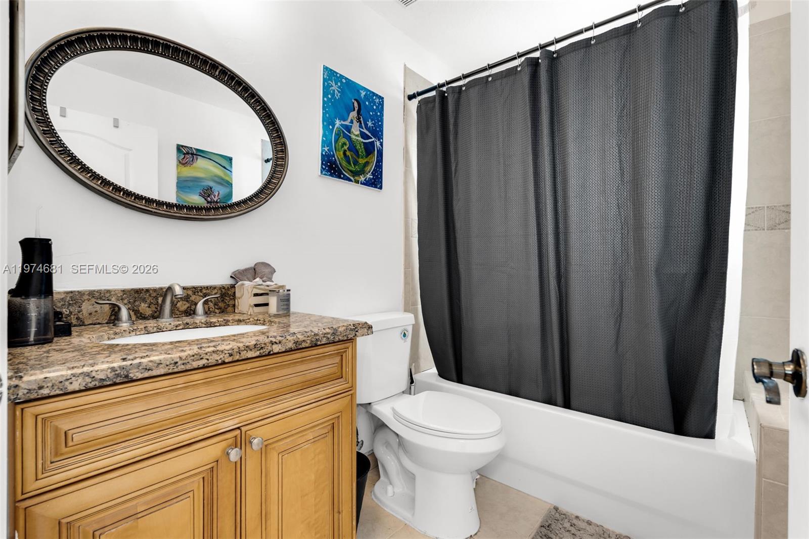 16610 Southwest 57th Lane Miami, FL 33193 - Photo 24 of 57 a bathroom with a granite countertop toilet sink vanity and mirror