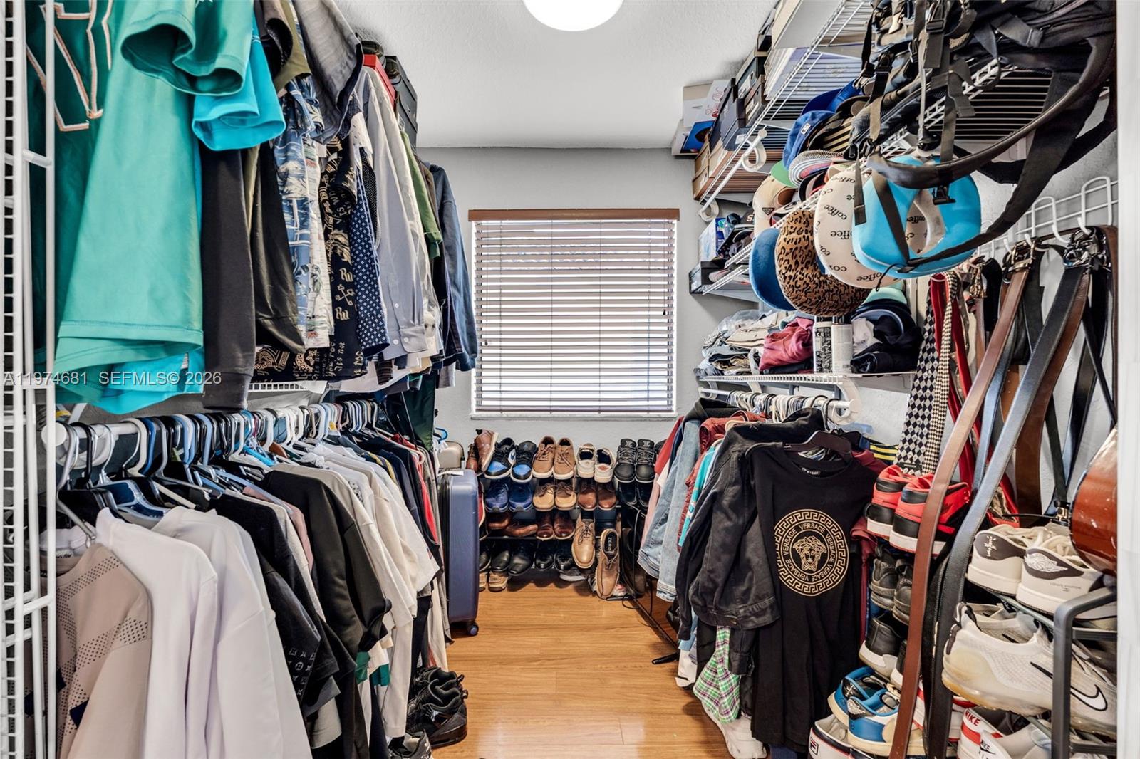 16610 Southwest 57th Lane Miami, FL 33193 - Photo 25 of 57 a view of walk in closet with clothes and shoes