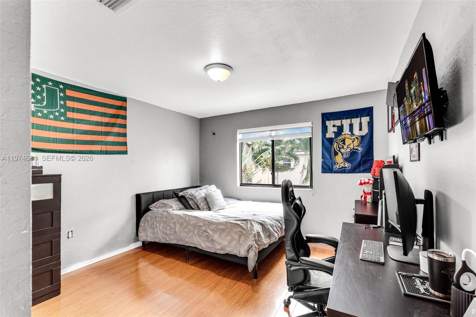 16610 Southwest 57th Lane Miami, FL 33193 - Photo 26 of 57 a bedroom with a bed and a flat screen tv