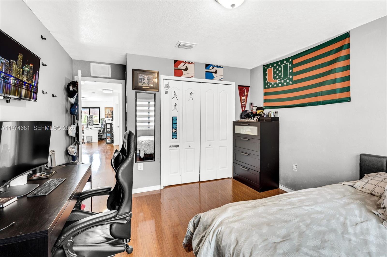 16610 Southwest 57th Lane Miami, FL 33193 - Photo 27 of 57 a bedroom with a bed and a flat screen tv