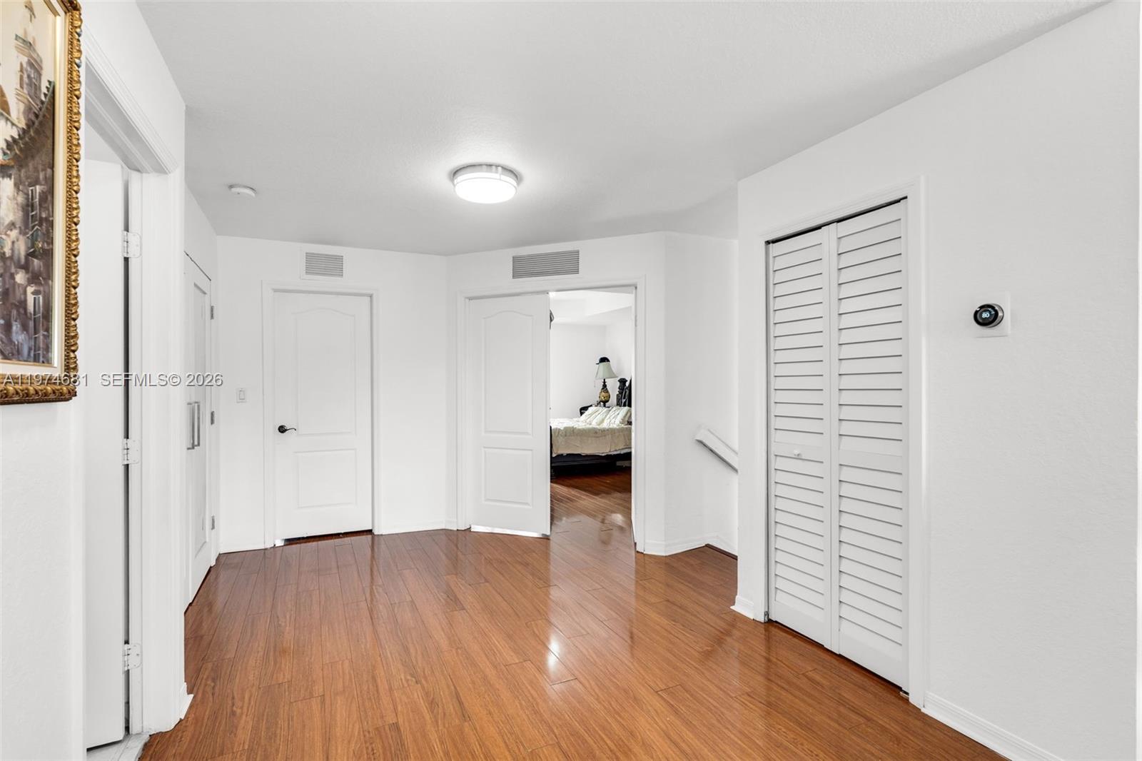16610 Southwest 57th Lane Miami, FL 33193 - Photo 28 of 57 a view of a hallway with wooden floor and a kitchen