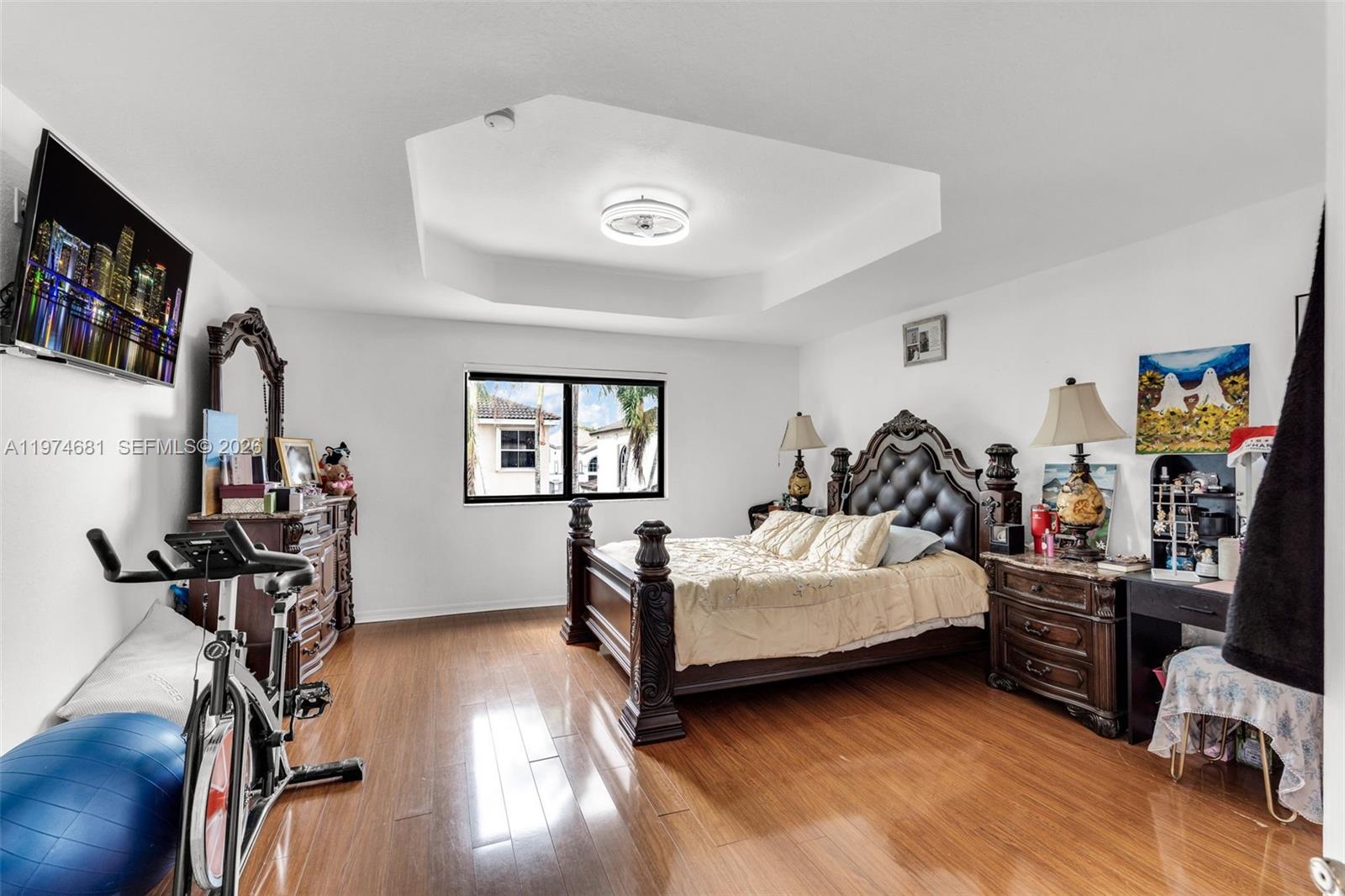 16610 Southwest 57th Lane Miami, FL 33193 - Photo 29 of 57 a bedroom with bed and a flat tv screen on the dresser