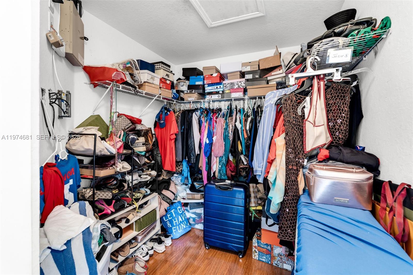 16610 Southwest 57th Lane Miami, FL 33193 - Photo 32 of 57 a view of walk in closet with clothes and shoes