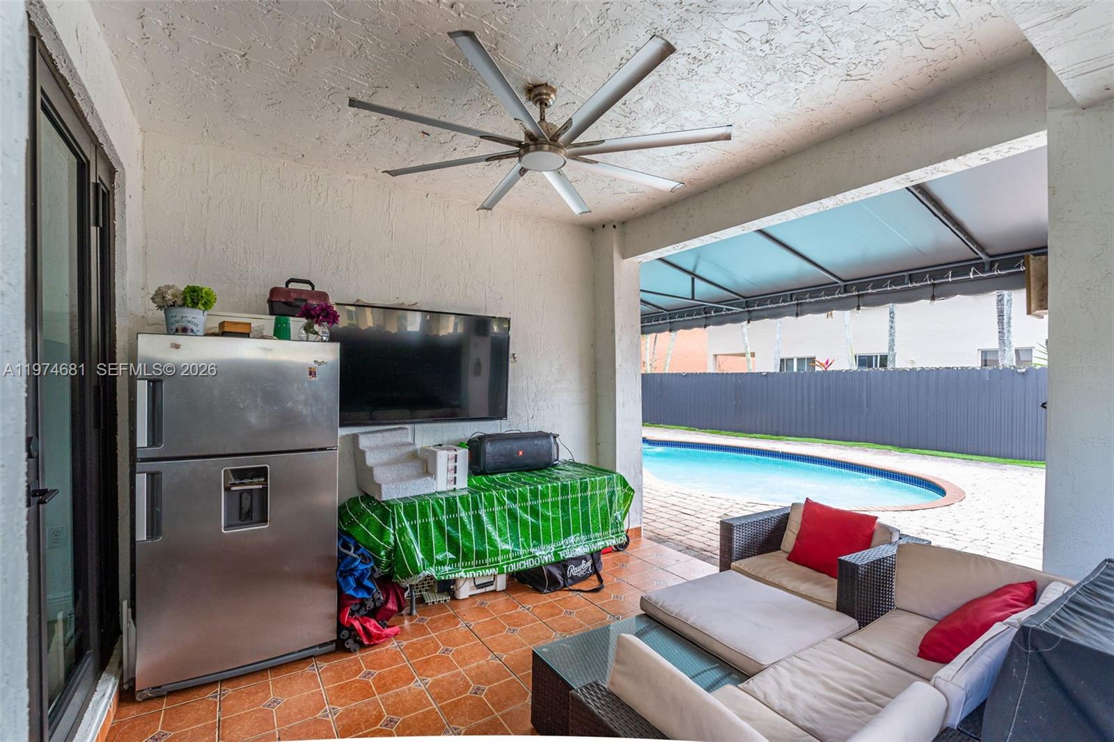 16610 Southwest 57th Lane Miami, FL 33193 - Photo 36 of 57 a living room with furniture and a flat screen tv