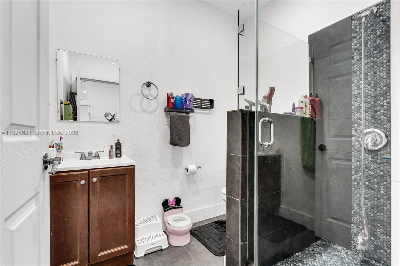 16610 Southwest 57th Lane Miami, FL 33193 - Photo 46 of 57 a bathroom with a sink toilet and shower