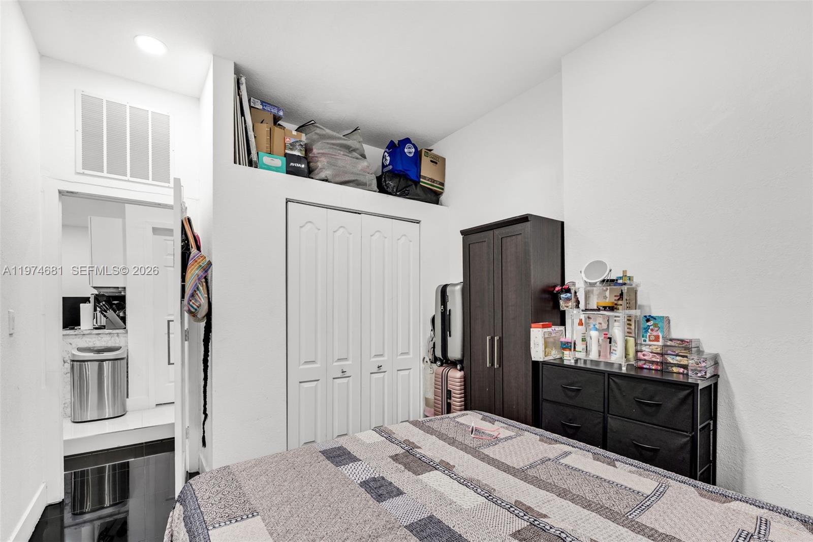 16610 Southwest 57th Lane Miami, FL 33193 - Photo 48 of 57 a bedroom with a bed and cabinets