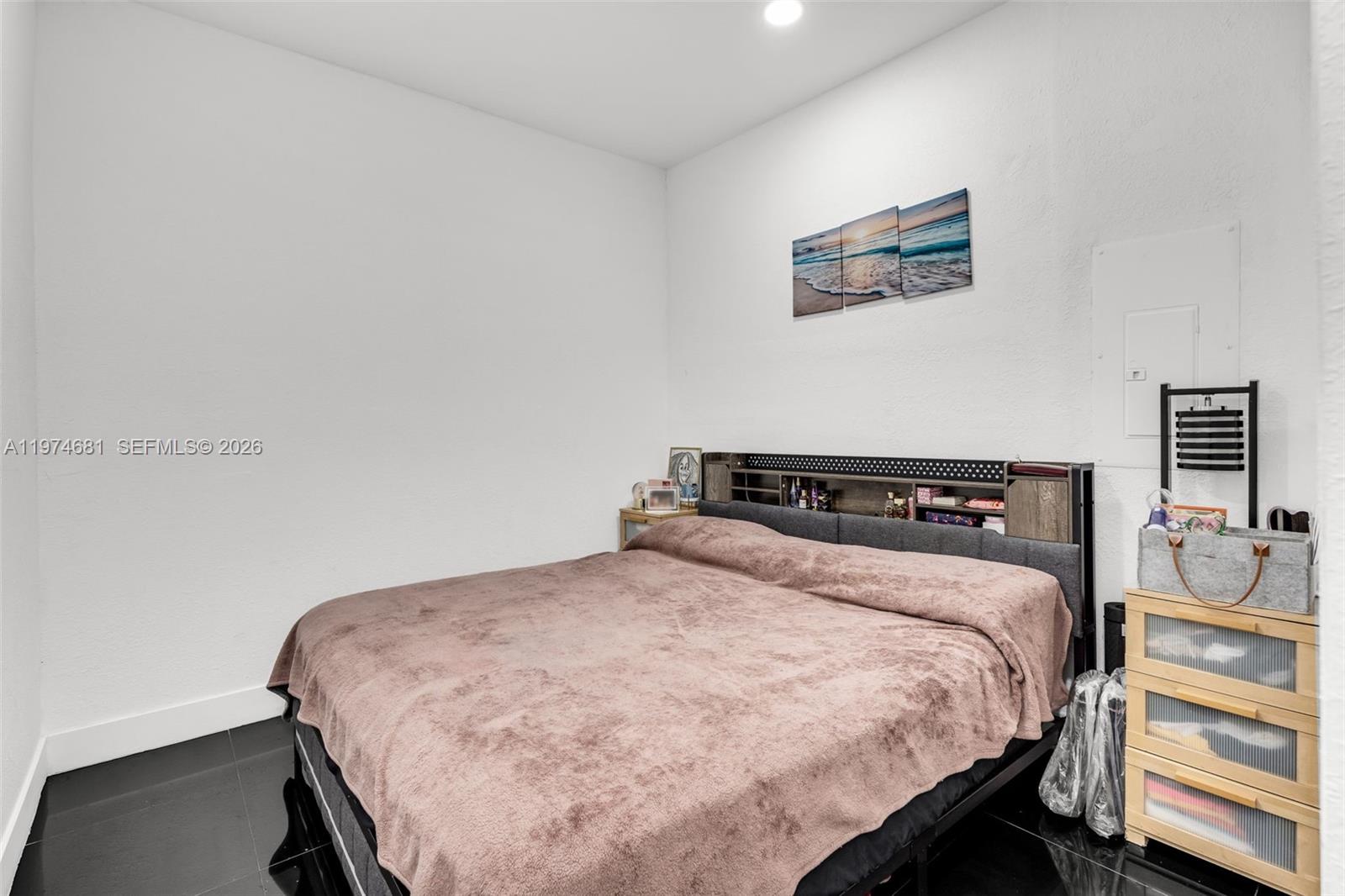 16610 Southwest 57th Lane Miami, FL 33193 - Photo 49 of 57 a bedroom with a bed and a night stand