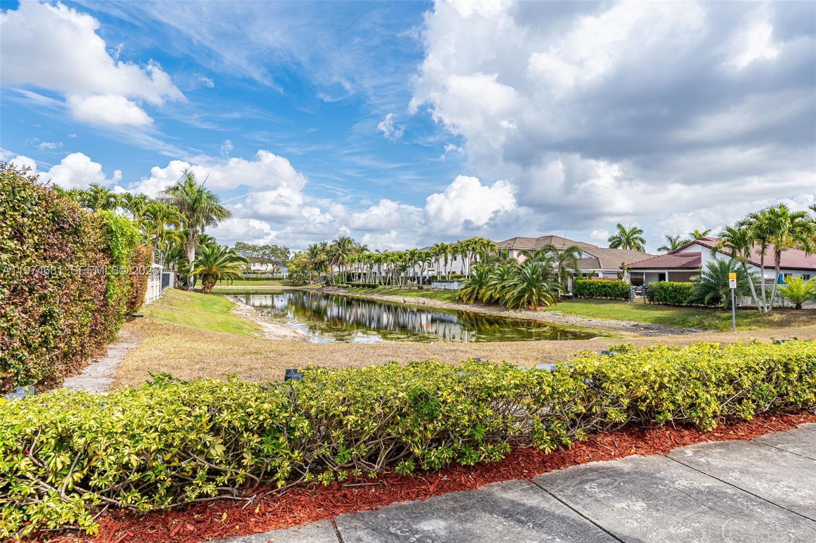 16610 Southwest 57th Lane Miami, FL 33193 - Photo 5 of 57 a view of a lake with a house in the background