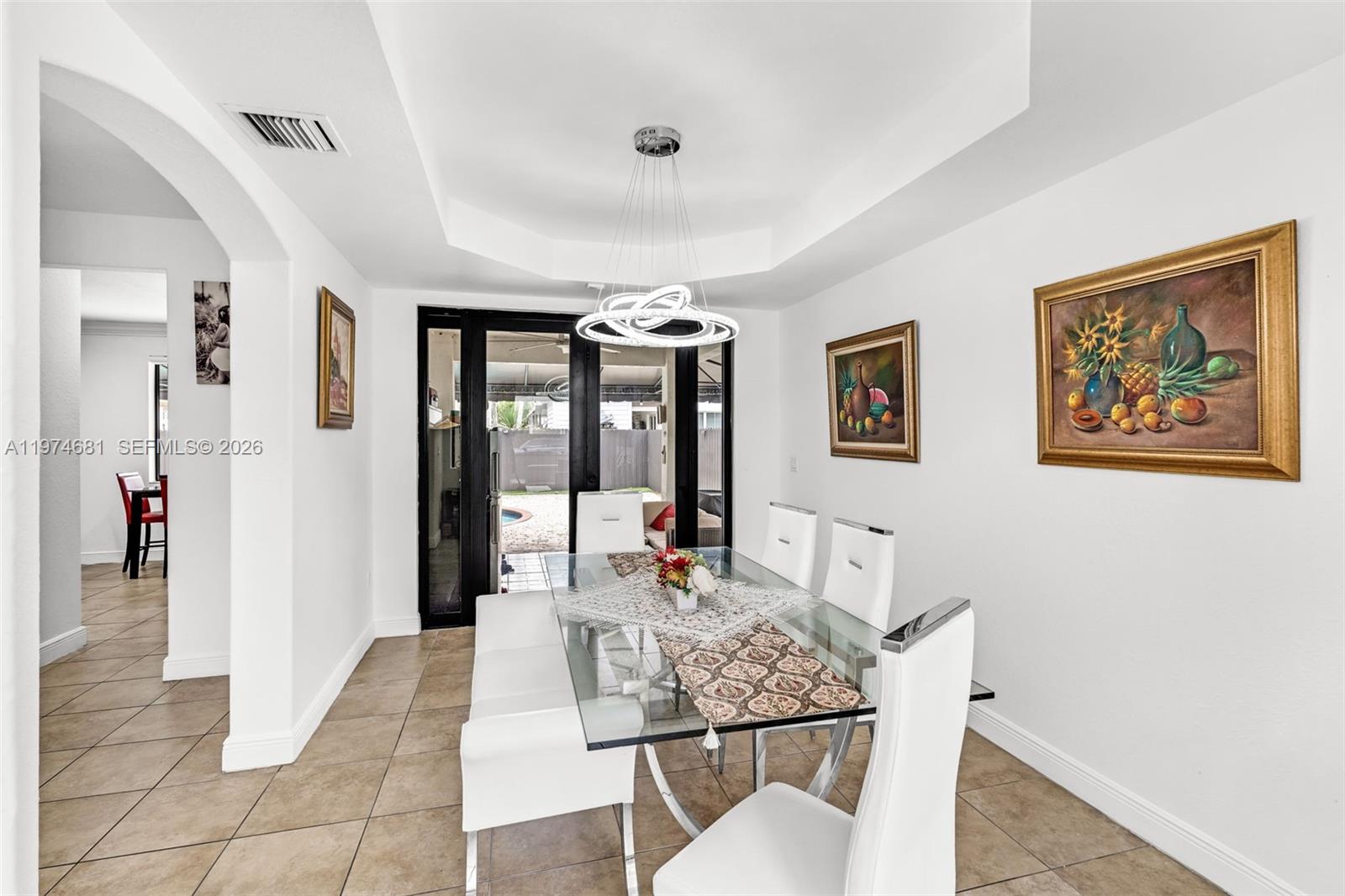 16610 Southwest 57th Lane Miami, FL 33193 - Photo 9 of 57 a living room with furniture a window and a dining table