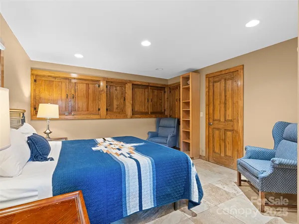 a bedroom with a bed and a painting on the wall