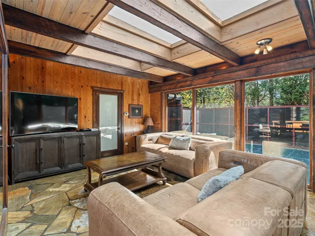 a bedroom with furniture and a large window