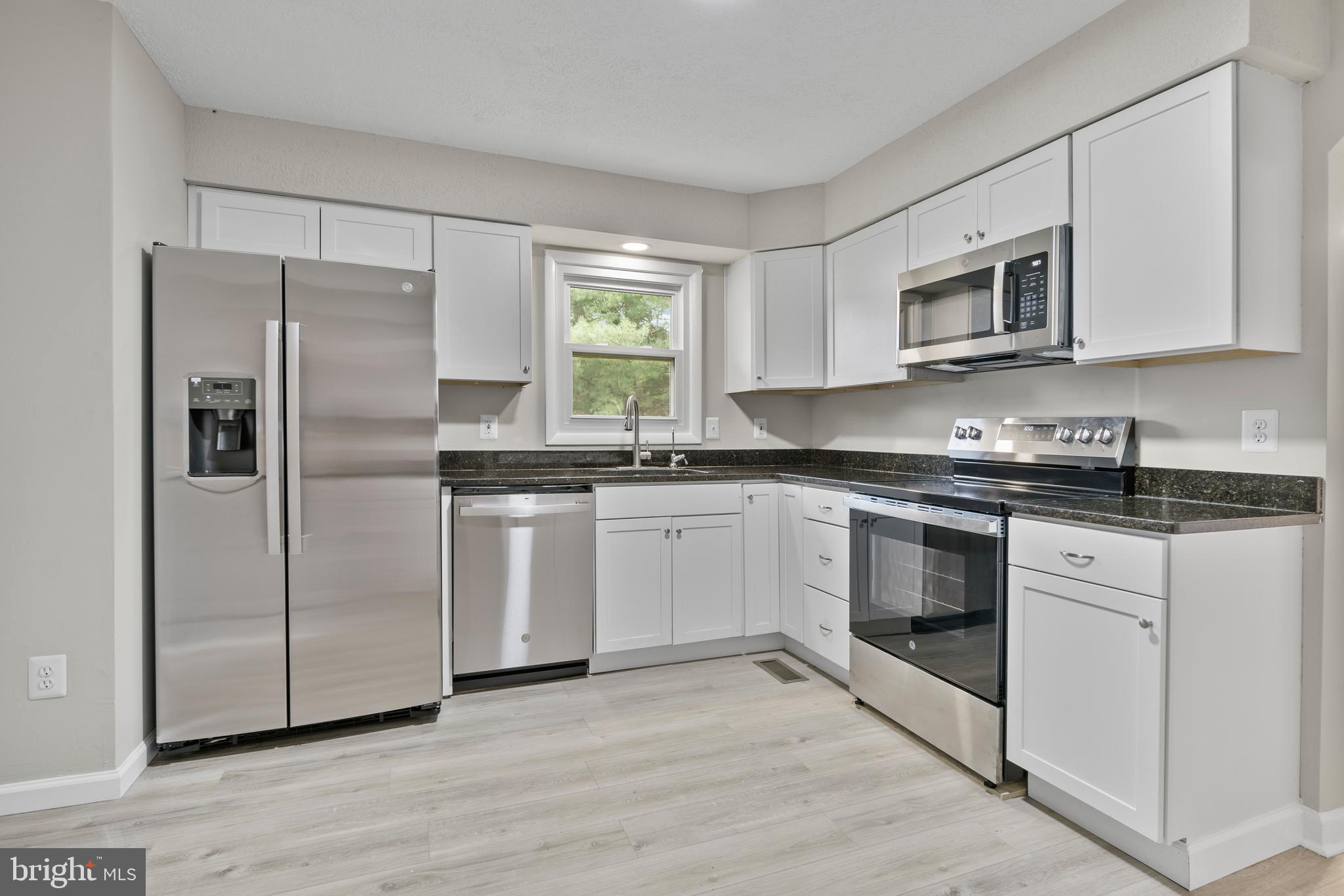 5134 Perry Road Mount Airy, MD 21771 - Photo 11 of 28 a kitchen with white cabinets stainless steel appliances and a window