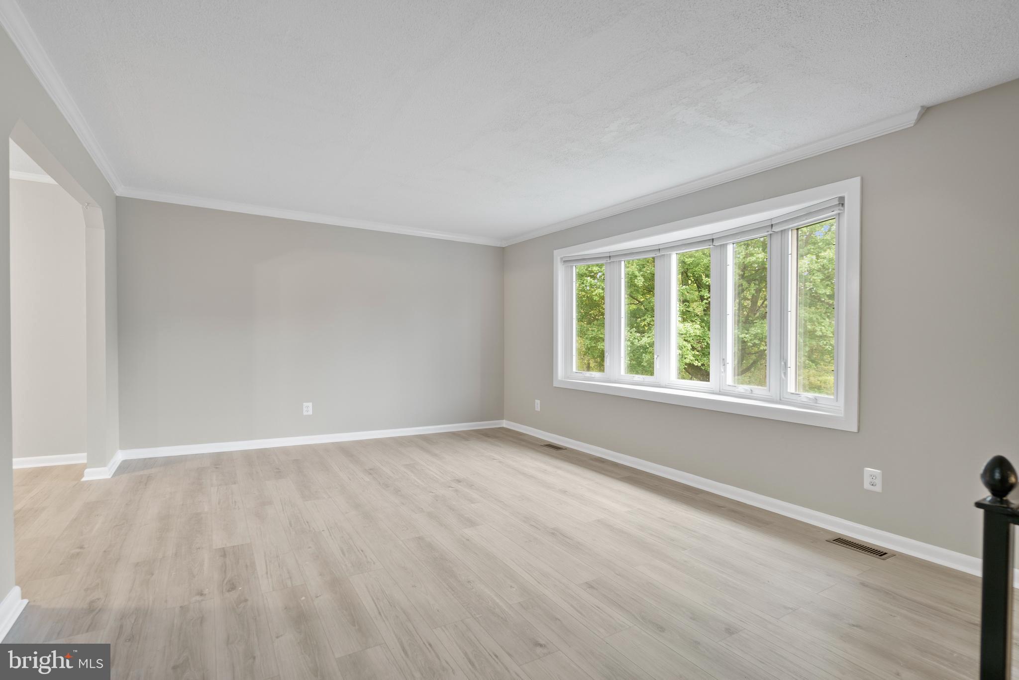5134 Perry Road Mount Airy, MD 21771 - Photo 5 of 28 a view of an empty room with wooden floor and a window