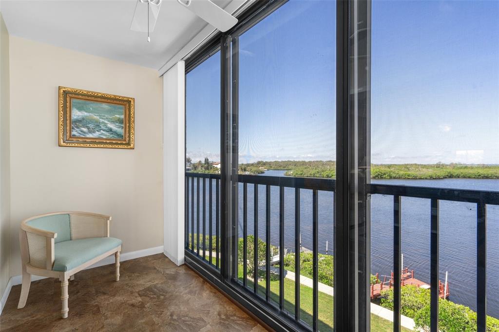 8141 Aquila Street, Unit 334 Port Richey, FL 34668 - Photo 15 of 61 a view of a hallway with wooden floor and a floor to ceiling window