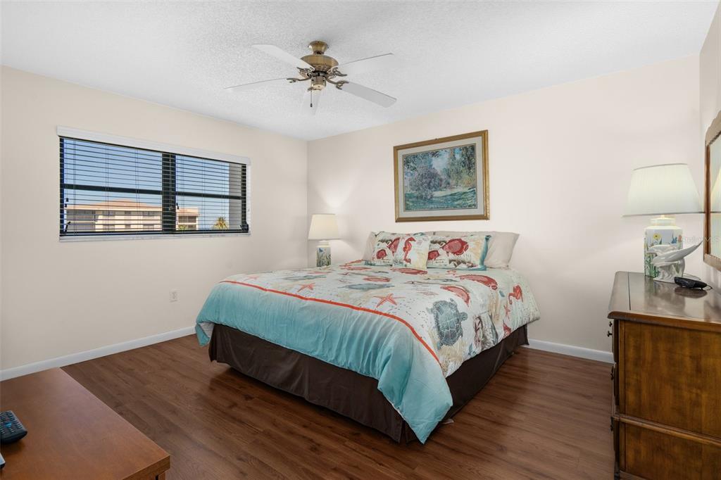 8141 Aquila Street, Unit 334 Port Richey, FL 34668 - Photo 23 of 61 a bedroom with a bed and painting on the wall