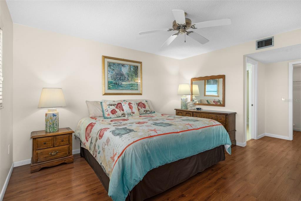 8141 Aquila Street, Unit 334 Port Richey, FL 34668 - Photo 24 of 61 a bedroom with a bed and a chandelier