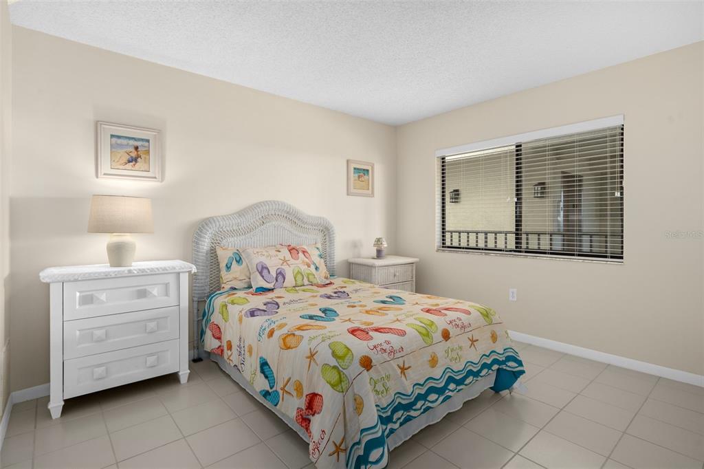 8141 Aquila Street, Unit 334 Port Richey, FL 34668 - Photo 31 of 61 a bedroom with a bed and a window