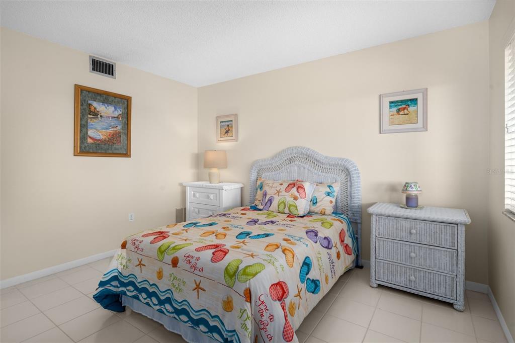 8141 Aquila Street, Unit 334 Port Richey, FL 34668 - Photo 32 of 61 a bedroom with a bed and dresser