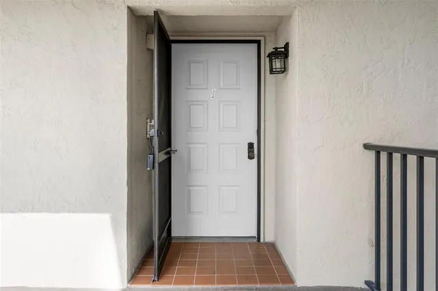 a view of a dining room with furniture a chandelier and wooden floor