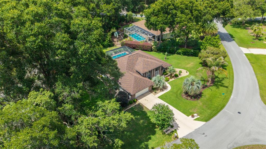 18825 Southwest 93rd Loop Dunnellon, FL 34432 - Photo 67 of 85 an aerial view of a house with a garden and trees all around