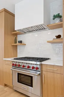 a kitchen with stainless steel appliances granite countertop a sink and a refrigerator