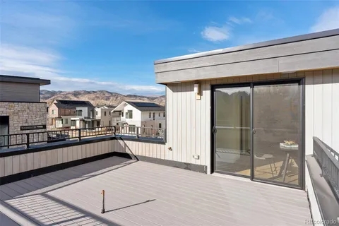 a view of balcony with furniture and wooden floor