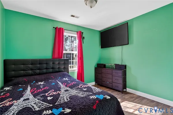 a bedroom with a bed and a television