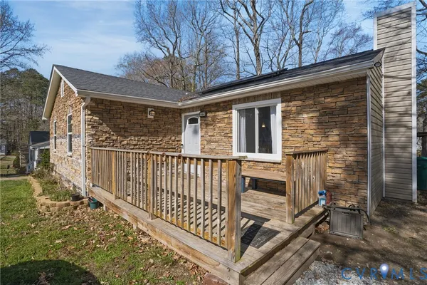 a view of a house with wooden fence and two windows