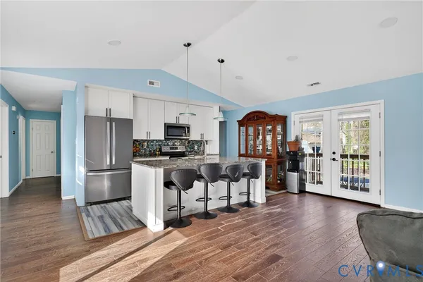 a open kitchen with white cabinets and stainless steel appliances