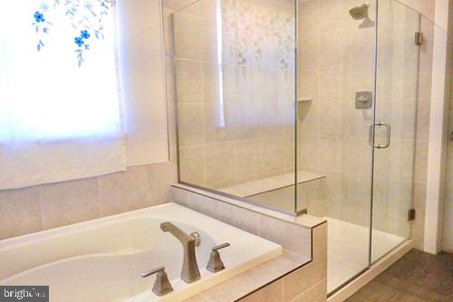 14905 Mapleridge Road Culpeper, VA 22701 - Photo 24 of 40 a bathroom with a bathtub and a shower