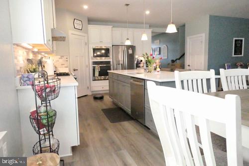14905 Mapleridge Road Culpeper, VA 22701 - Photo 27 of 40 a kitchen with refrigerator and cabinets