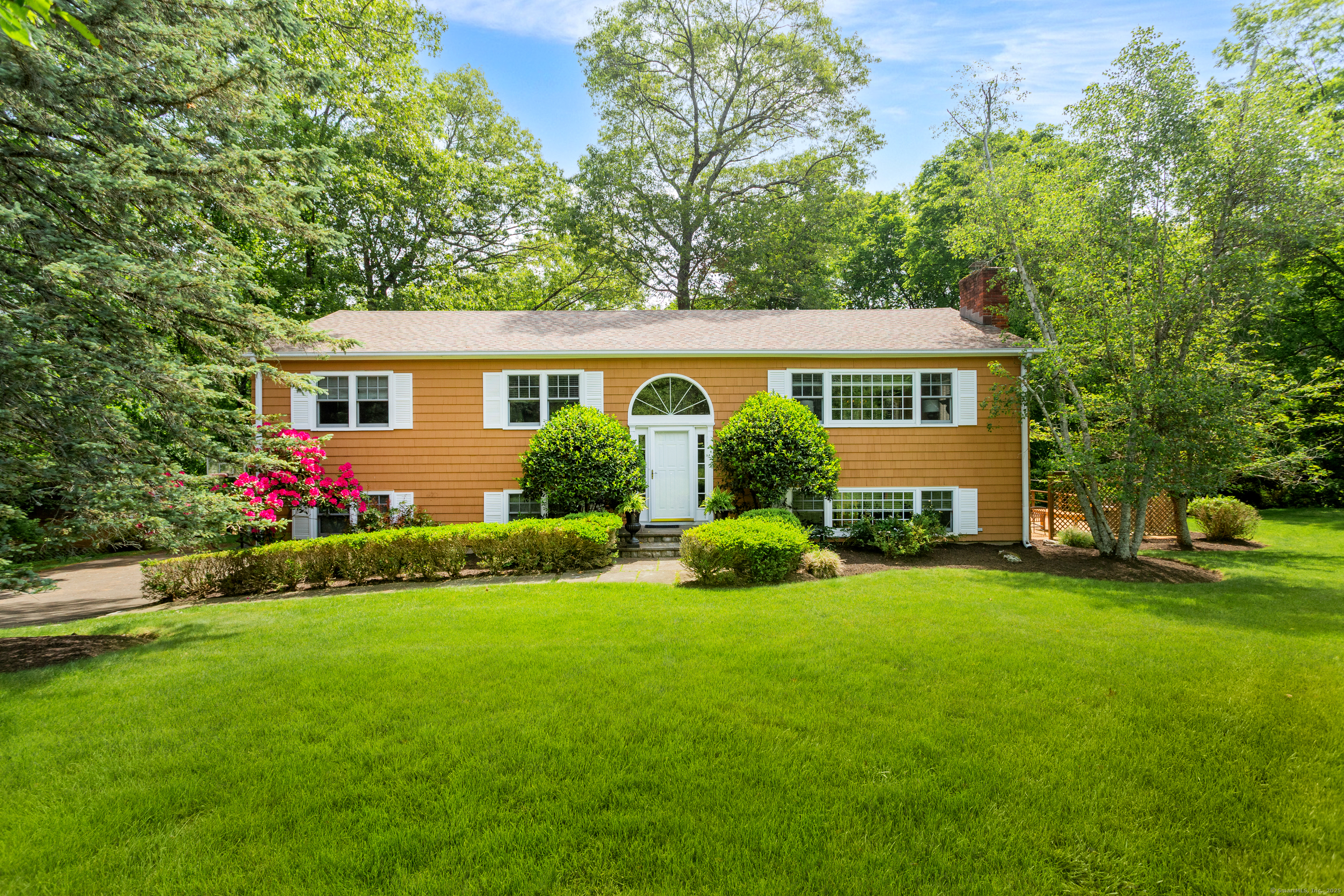 a front view of house with yard and green space
