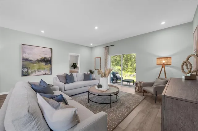 a living room with furniture and a large window