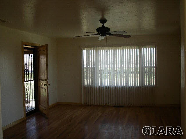1689 18 Road Fruita, CO 81521 - Photo 10 of 35 a view of empty room with wooden floor and fan