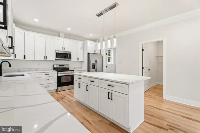 an empty room with windows and wooden floor