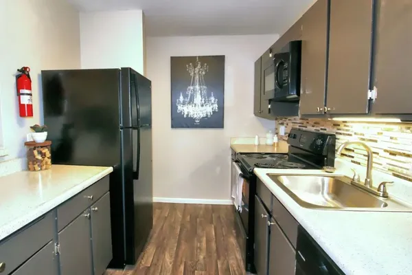 a kitchen with a sink and a refrigerator