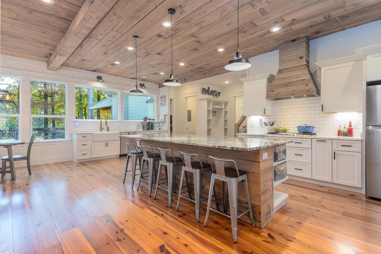 570 Wildwood Road Eads, TN 38028 - Photo 2 of 38 a kitchen with stainless steel appliances granite countertop wooden floors and white cabinets