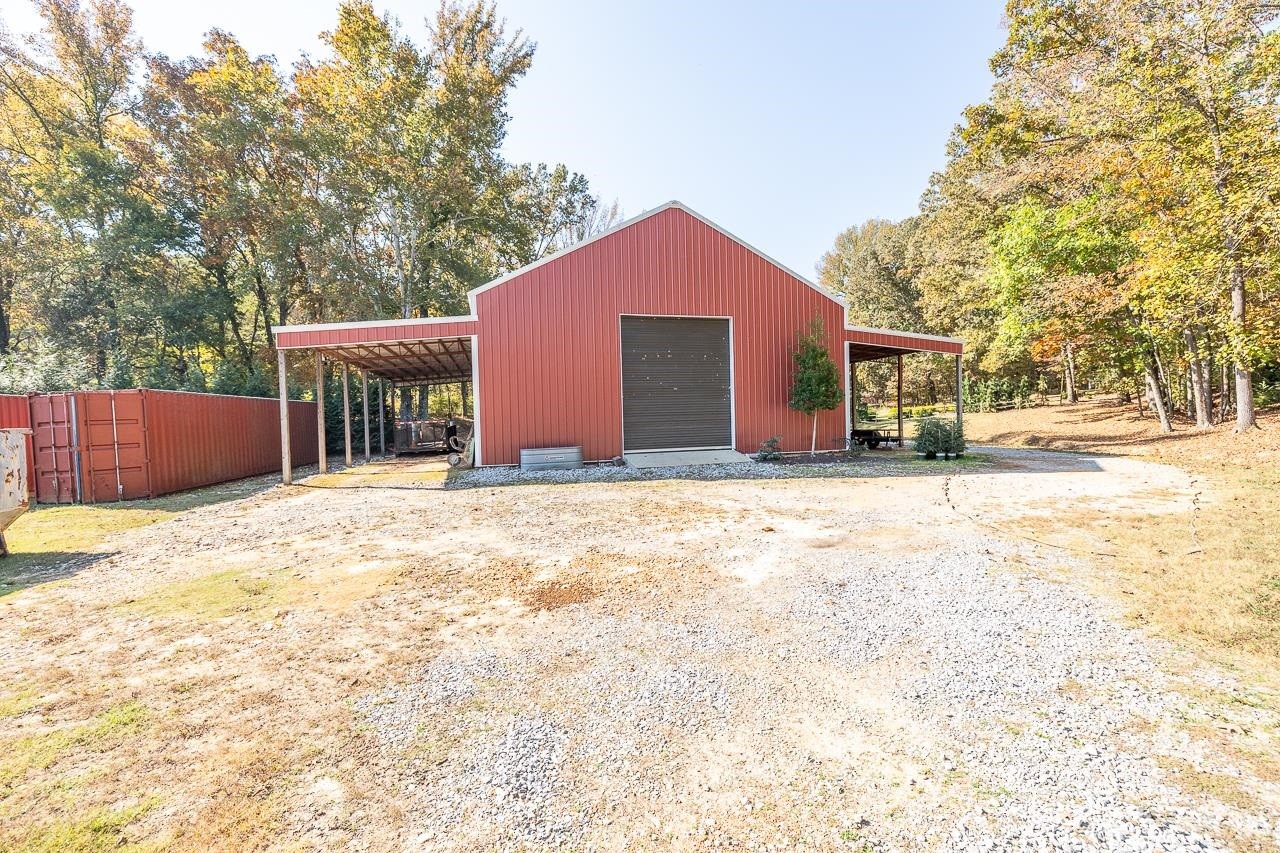 570 Wildwood Road Eads, TN 38028 - Photo 37 of 38 a wooden house with a yard