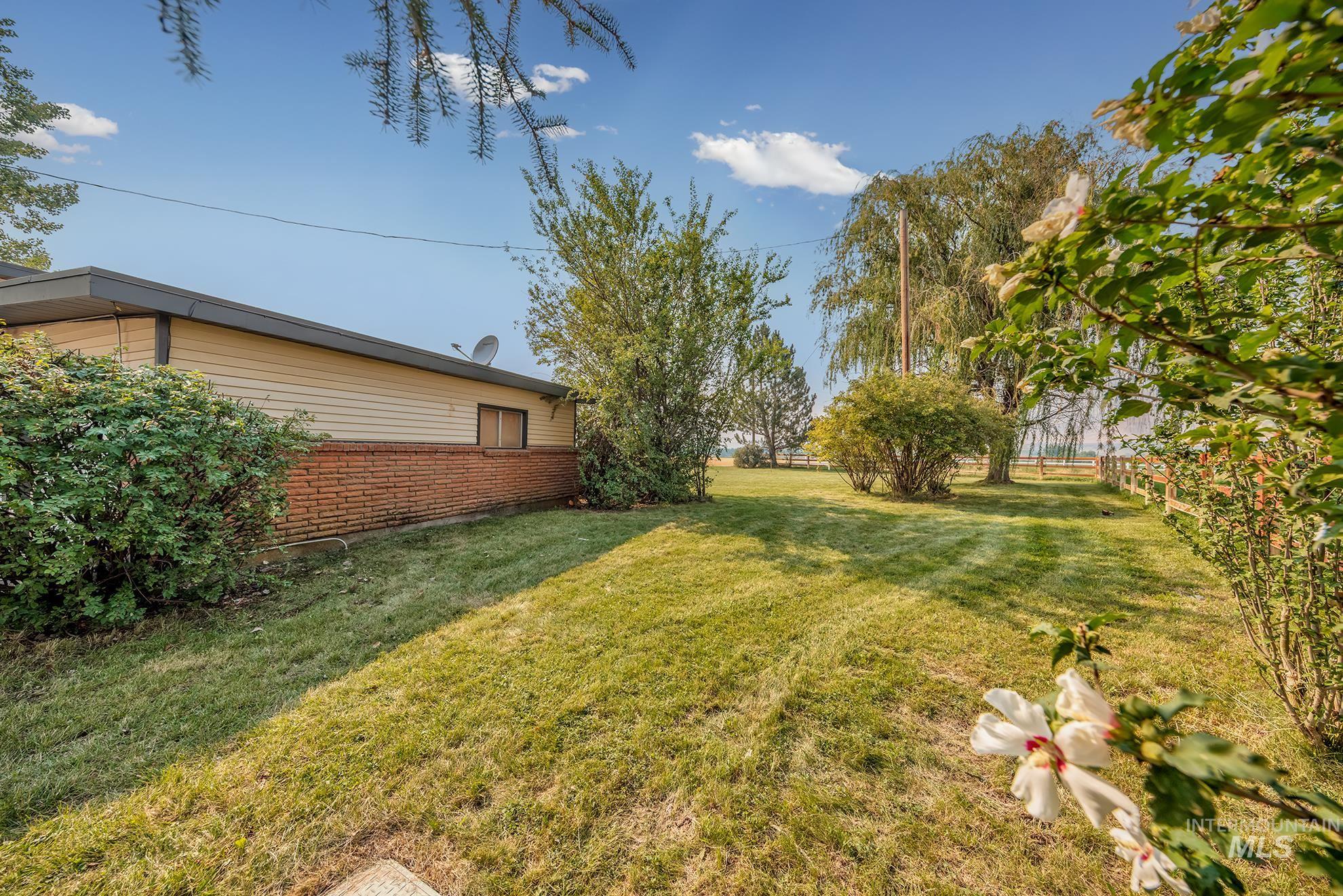 1741 Cove Road Weiser, ID 83672 - Photo 31 of 46 Expansive green lawn with mature trees and established shrubbery