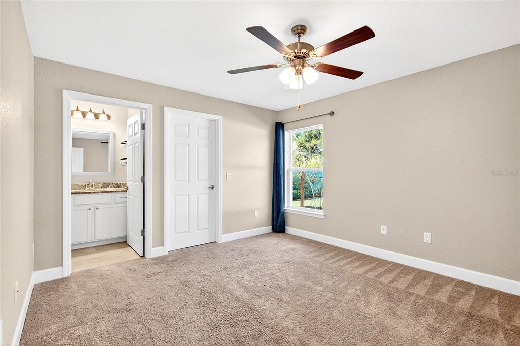 501 Marion Oaks Golf Road Ocala, FL 34473 - Photo 21 of 33 an empty room with windows and fan