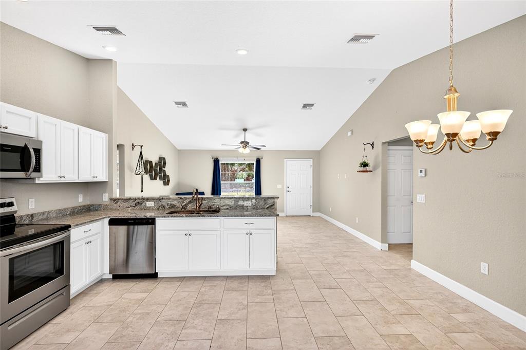 501 Marion Oaks Golf Road Ocala, FL 34473 - Photo 8 of 33 a kitchen with granite countertop a sink and cabinets