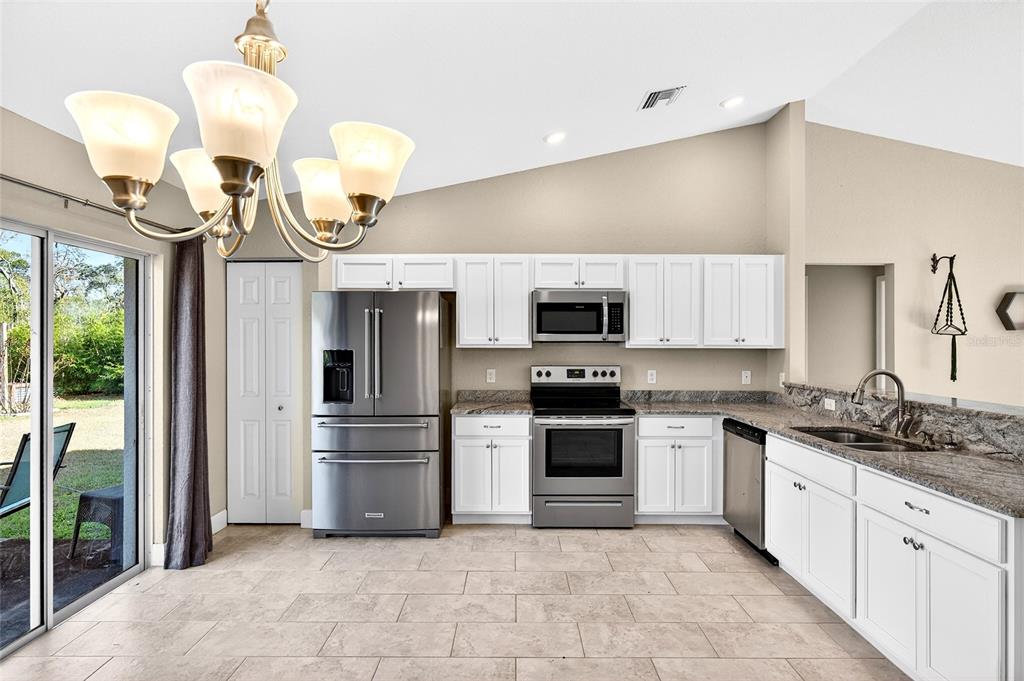 501 Marion Oaks Golf Road Ocala, FL 34473 - Photo 9 of 33 a kitchen with a sink stainless steel appliances and cabinets