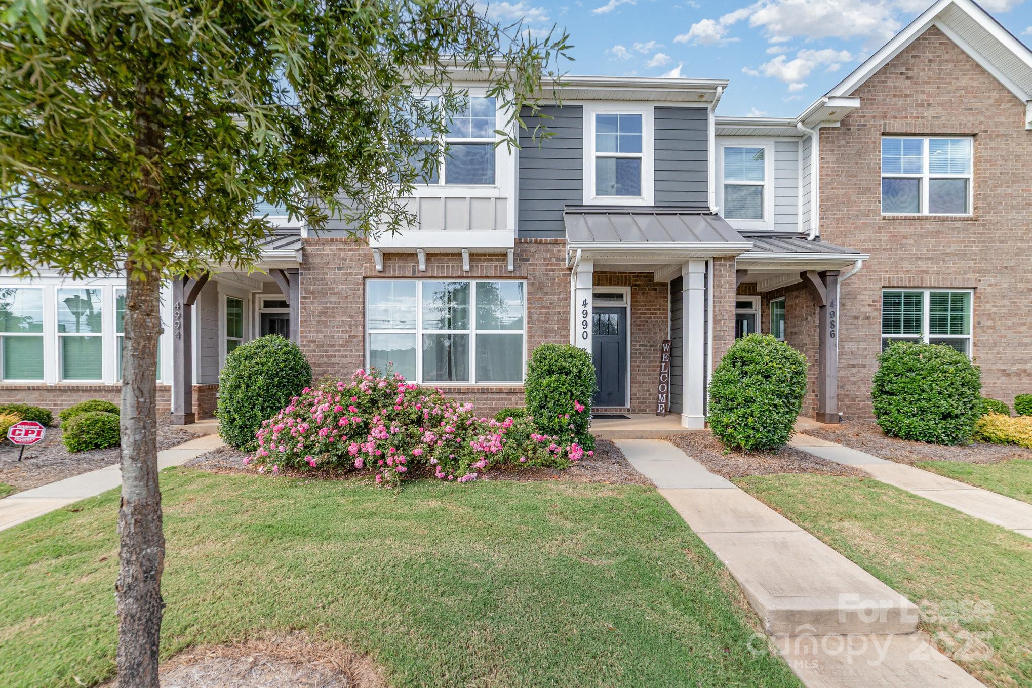 a front view of a house with garden