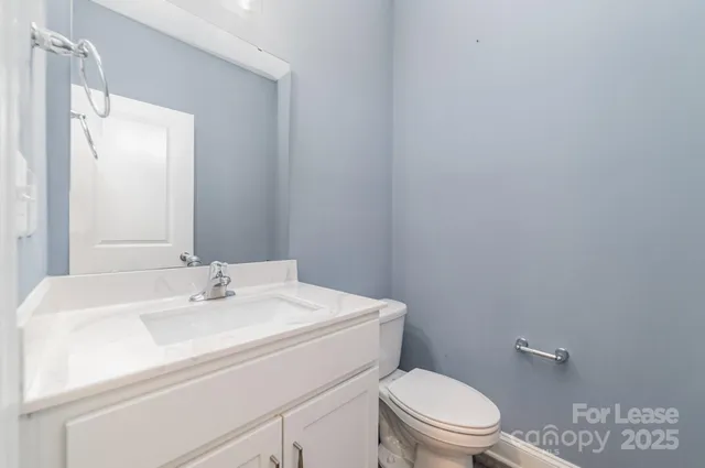 an empty room with windows and ceiling fan