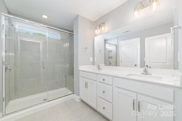 an empty room with a window and a ceiling fan